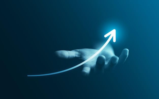 Hand holding rising arrow symbolizing business growth and success"
